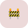 A construction barrier with black and yellow diagonal stripes and two orange warning lights on top, set against a pale pink background—ideal for sites needing coastal termite and pest control protection.